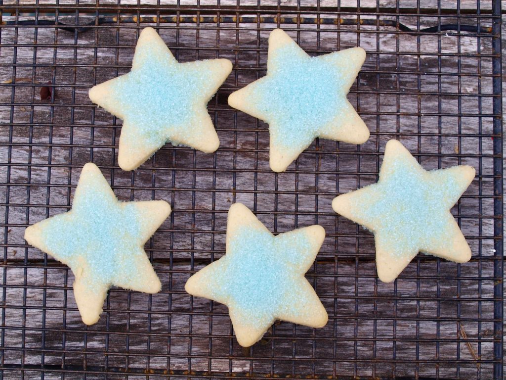 five star shaped cookies on a cooling rack